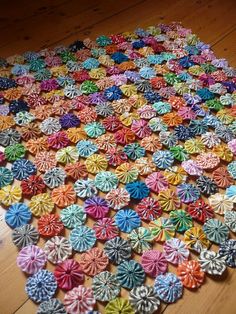 a multicolored rug made out of paper flowers