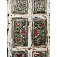 an old wooden door with floral designs painted on it