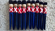 a group of wooden toy soldiers lined up in a row on the floor next to each other