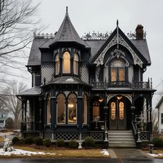 an old victorian style house is decorated in black and white with ornate trimmings