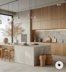 a modern kitchen with marble counter tops and wooden cabinets, along with stools in front of the island