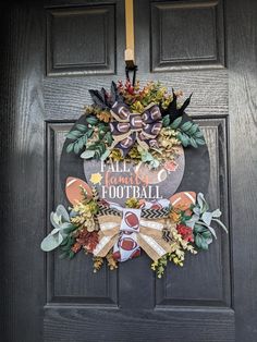 a football wreath hanging on a door with the words, all i want for football