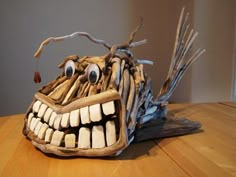 a paper mache made to look like a monster's head with teeth and fangs