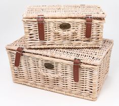 two wicker baskets with brown leather handles