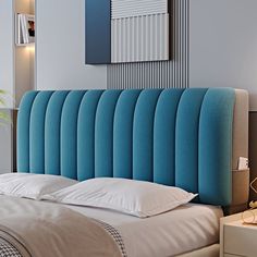 a blue headboard on a bed with white pillows