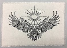 a piece of cloth with an image of a bird on it's wings and the sun in the background