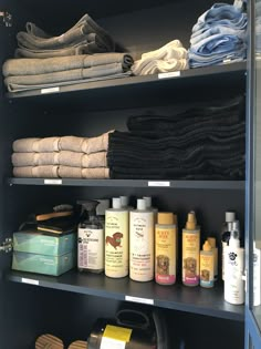 the shelves are filled with many different types of towels and other household care products for sale