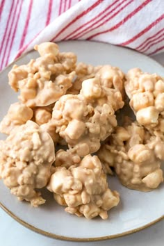 a white plate topped with cookies covered in peanut butter