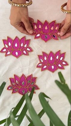 the woman is making decorative designs on her table cloths with beads and stones for decoration