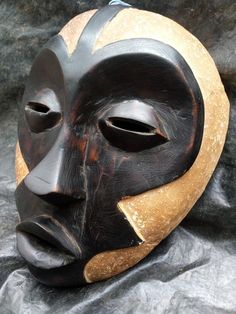 a wooden mask sitting on top of a table