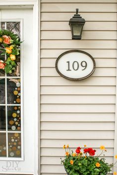 a dog is standing in front of a door with a wreath on it's side