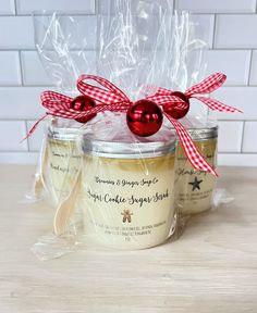 three jars with christmas decorations in them sitting on a table