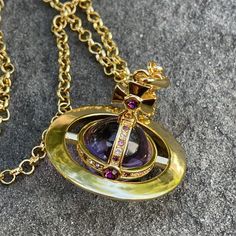 This Vivienne Westwood Necklace Is A Stunning Piece Of Fashion Jewelry. The Gold Chain Features A Giant Orb Pendant In A Beautiful Shade Of Purple. The Necklace Has A Stylish Charm That Will Make It A Perfect Accessory For Any Outfit. With Its Unique Style, This Necklace Is Sure To Stand Out And Make A Statement. The Vivienne Westwood Logo Adds A Touch Of Luxury To This Beautiful Piece. Perfect For Those Who Want To Add A Touch Of Elegance And Sophistication To Their Look. Things To Note: * In Beautiful Preloved Condition * Box And Dust Bag Not Included * 100% Authentic Vivienne Westwood Giant Orb Necklace, Jewelry Vivienne Westwood, Vivienne Westwood Necklace, Vivienne Westwood Logo, Westwood Necklace, Vivienne Westwood Orb, Vivienne Westwood Jewelry, Orb Necklace, Vivienne Westwood Jewellery