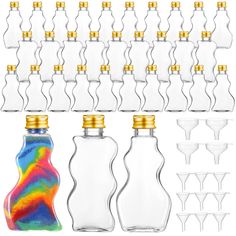 several bottles and glasses are lined up against a white background