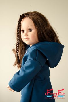 the doll is wearing a blue coat and has long hair in it's ponytail