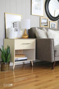 a living room scene with focus on the couch and side table in the foreground