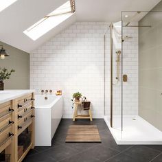 an attic bathroom with white brick walls and black tile flooring, along with a walk in shower