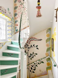 the stairs are decorated with colorful wallpaper