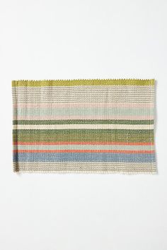 a multicolored striped table runner on a white background