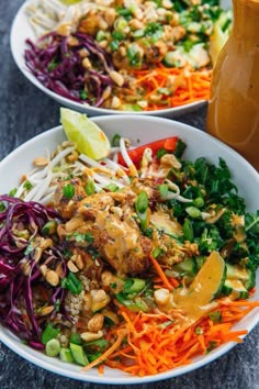 two white bowls filled with different types of salads and dressing next to each other