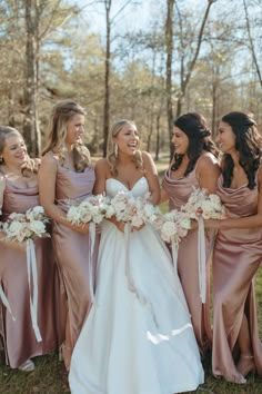 the bride and her bridesmaids are laughing together