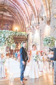 a bride and groom are standing in front of the alterp at their wedding ceremony