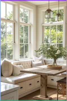 a living room filled with lots of windows next to a wooden table and couches