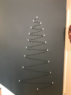 a christmas tree made out of lights on the wall