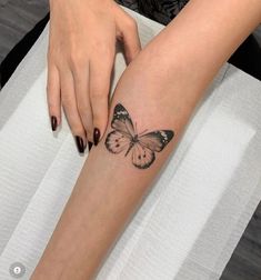 a woman's leg with a butterfly tattoo on it