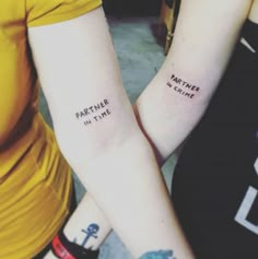 two people with matching tattoos on their arms that say partner in time and part time