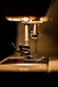 the sewing machine is close up in the dark