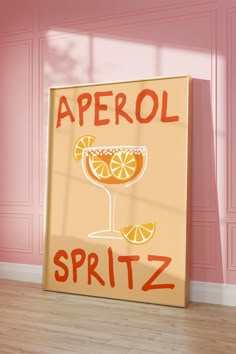 a sign that says aperol spritz on it in front of a pink wall