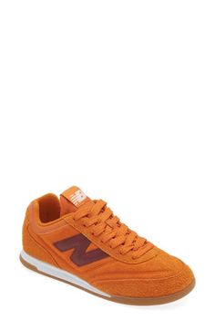 Minimal detailing brings maximum versatility to a low-top sneaker styled with a streamlined profile and grippy tread that smartly grounds any favorite look. Lace-up style Removable insole Synthetic upper and lining/rubber sole Imported Unisex Shoes Sneakers, Size 12 Women, Orange Shoes, Up Styles, Low Top, Sneakers Fashion, New Balance, Top Sneakers, Womens Sneakers