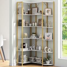 a white and gold book shelf in a room