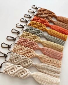 a row of different colored tassels on a white surface