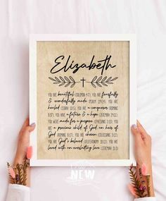 two hands holding up a framed print with the words elizabeth and an arrow on it