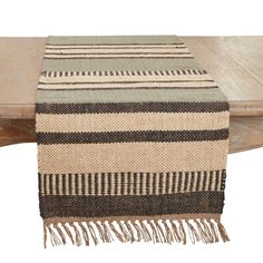 a striped table runner on top of a wooden bench