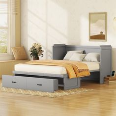 a bed sitting on top of a hard wood floor next to a dresser and window