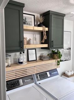 a washer and dryer in a laundry room with cabinets above the washer