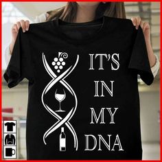 a woman holding up a t - shirt that says it's in my dna