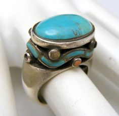 Unusual Vintage Sterling Silver Ring Turquoise Cabochon Mixed Stone Inlay Beads As Is. Marks-925 Only. Face Measures Approximately 1/2" Tall and 3/4" Wide. It is a Size 6 and Weighs 13 grams. Sold As Is Due to 2 Broken Beads, and 1 Missing.  Still very attractive! Vintage Turquoise Stone Jewelry, Vintage Turquoise Jewelry With Stones, Vintage Blue Turquoise Ring With Natural Stones, Luxury Artisan Turquoise Cabochon Ring, Vintage Turquoise Cabochon Ring, Artisan Silver Turquoise Cabochon Ring, Collectible Turquoise Cabochon Ring, Silver Turquoise Cabochon Ring, Turquoise Statement Ring