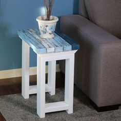 a white and blue table with a plant on top