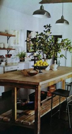 a wooden table sitting in the middle of a kitchen