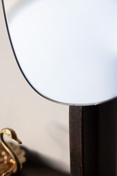 a close up of a lamp on a table with a pair of gold scissors next to it