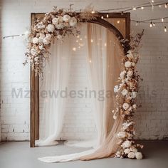 a wedding arch decorated with flowers and lights