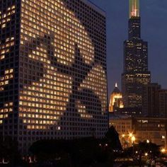 the silhouette of a man is projected on the side of a building in chicago, illinois