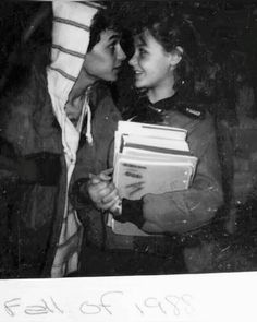 an old photo of two people holding books