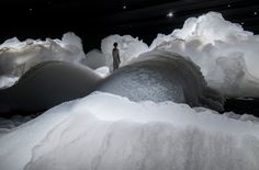 a man standing in the middle of piles of snow