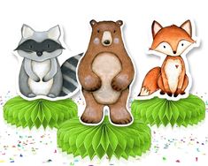 three cute little animals sitting on top of green leaves