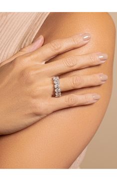 a woman's hand wearing a diamond ring